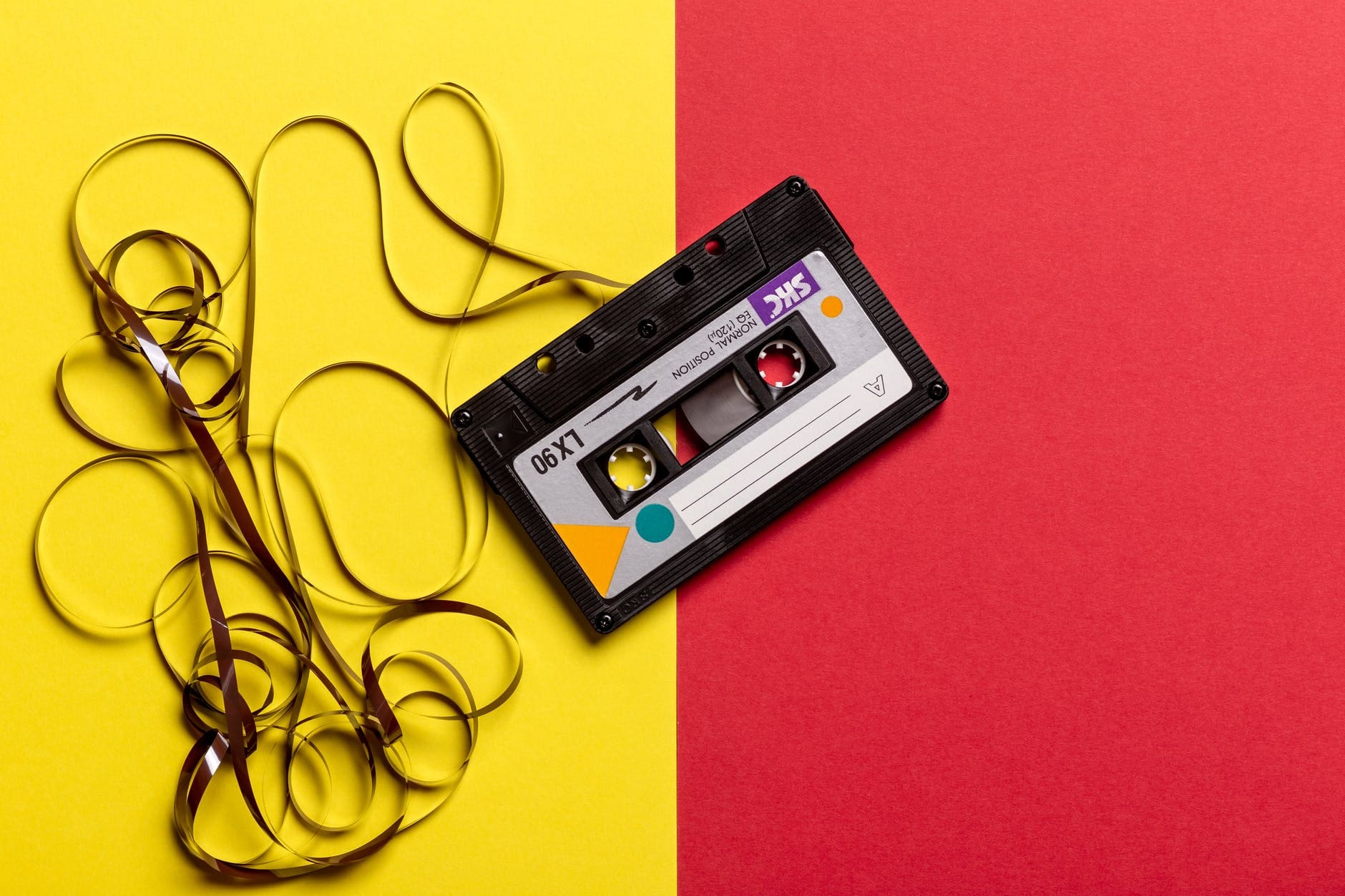 類比音樂(Analogy)與數位音樂(Digital)// 卡式帶 //black cassette tape on top of red and yellow surface